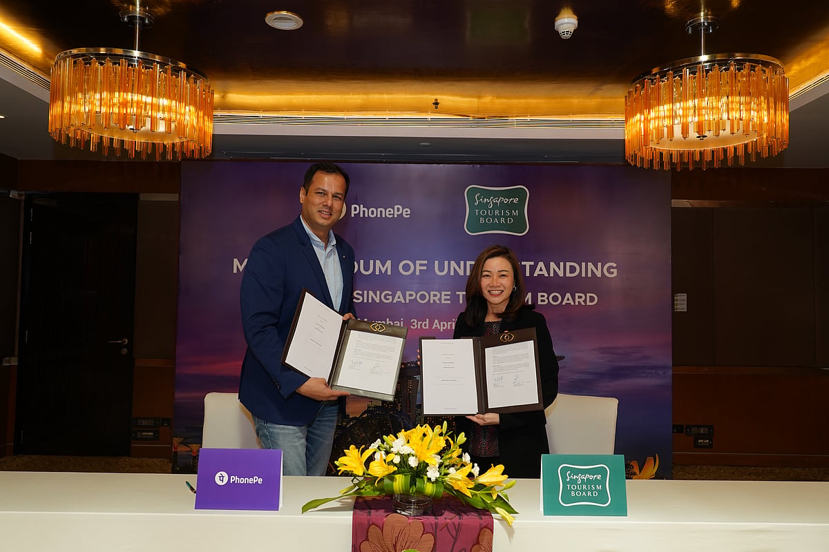 Melissa Ow and Ritesh Pai display the Memorandum of Understanding (MoU) signed at the event