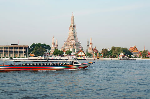 The iconic Temple of Dawn or Wat Arun with the famous Chao Phraya River
