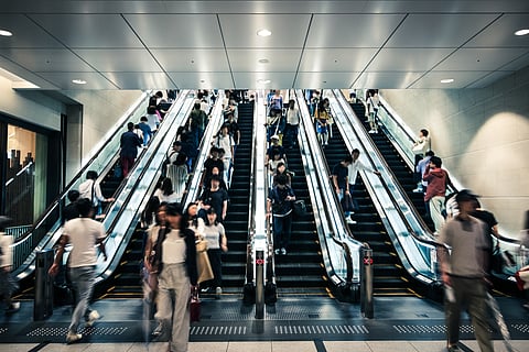 The people in this photograph are standing on their right, which is the norm in the Kansai region