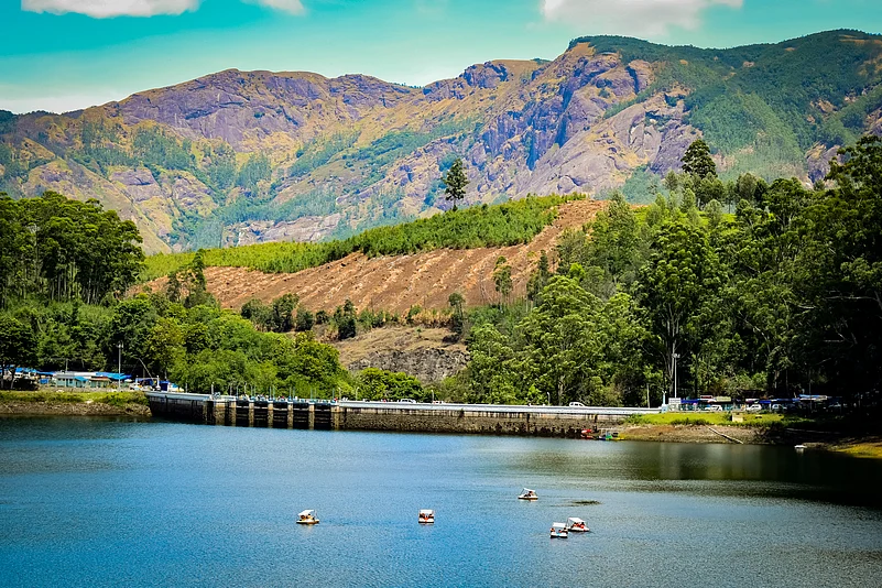 A view of the Mattupetty Dam under golden sunlight