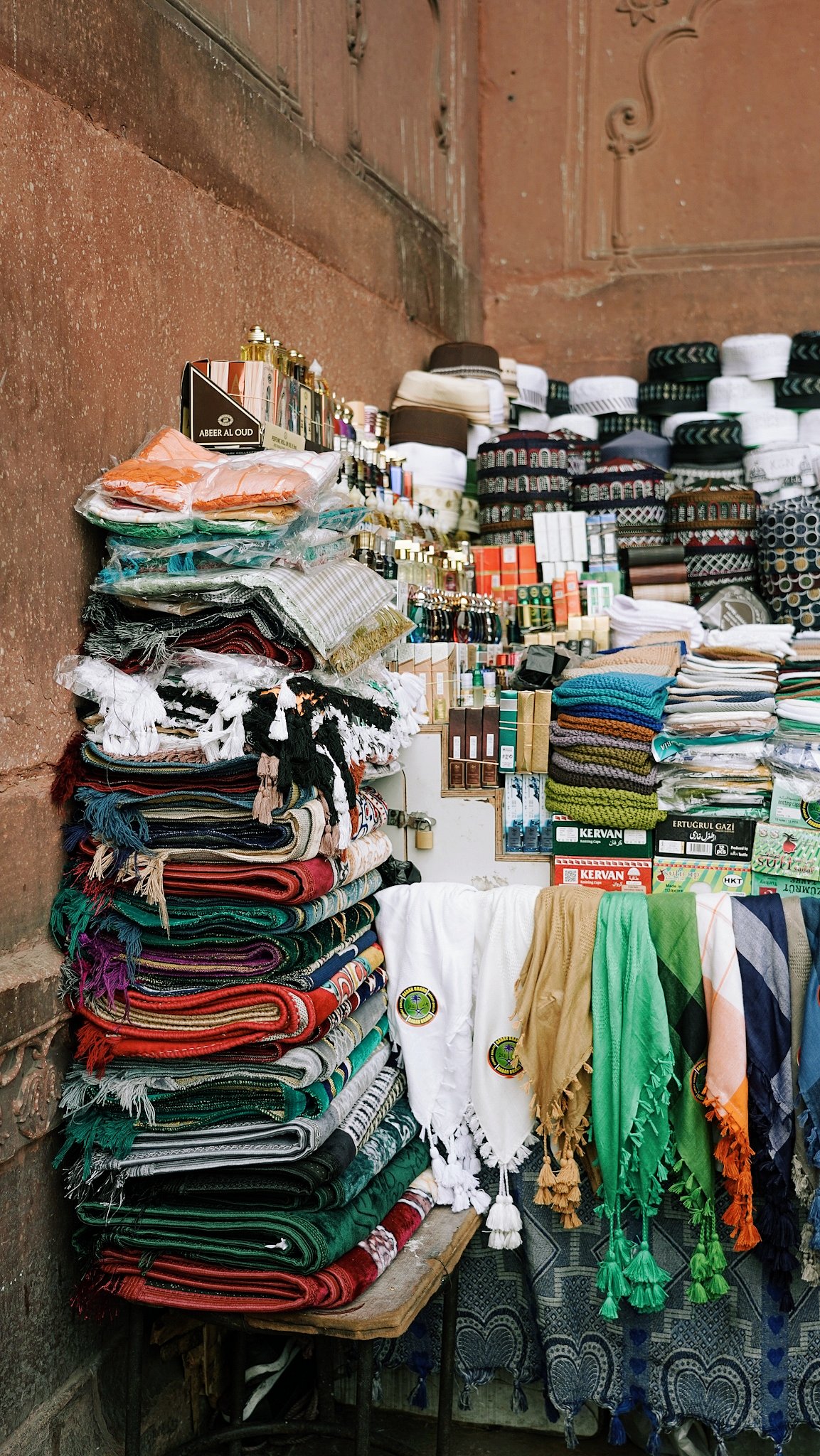 As you reach the mosque stairs, you'll also spot a small vendor selling various prayer essentials. They have everything you might need, from janamaz (prayer rugs) and ittar (attar) to skullcaps, kerchiefs, keffiyeh scarves, and more.