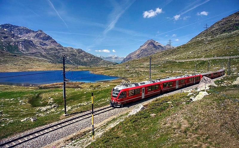 Ride the red swiss train gliding through the Alps