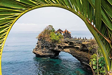 Photo: Getty Images : Perched on a rocky headland, Pura Batu Bolong is one of Indonesias most scenic Hindu temples