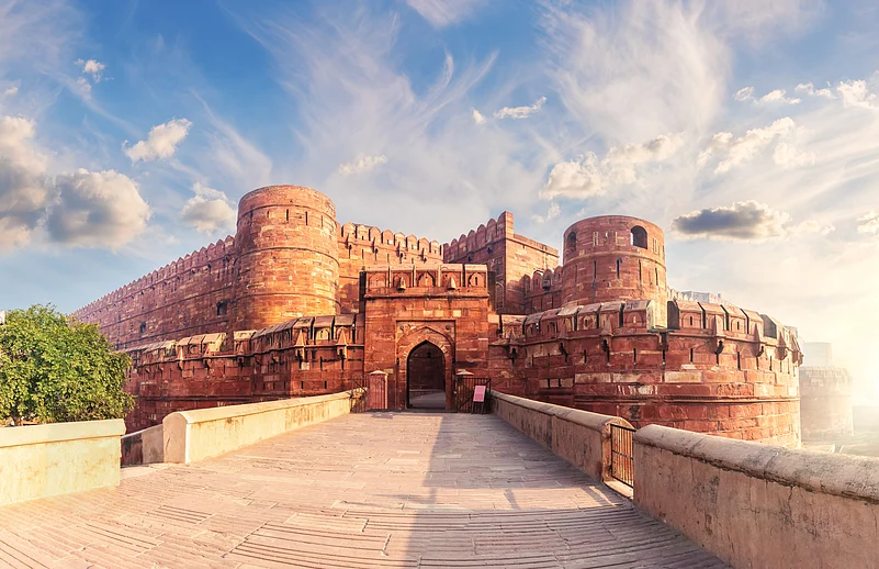 The front facade of the Agra Fort during sunrise
