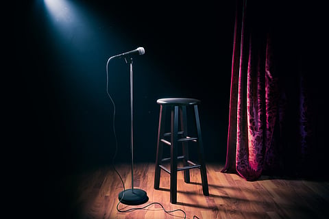 A stage is set for a comedian to take up
