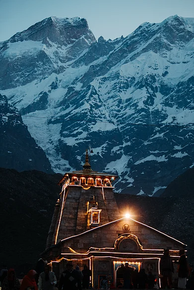 Shutterstock : Kedarnath temple lights at night with mountains in the background in Uttarakhand