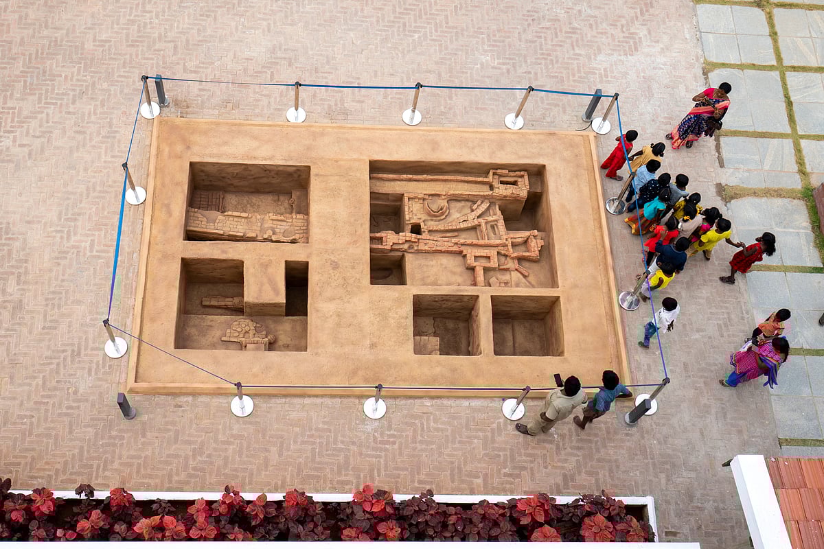 Visitors explore a model of an excavation at the museum 