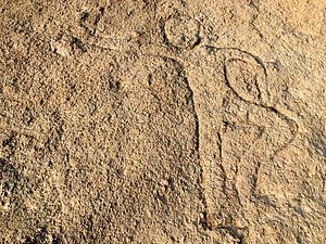 Shutterstock : A figure of a man at Usgalimal Rock Engravings, Goa