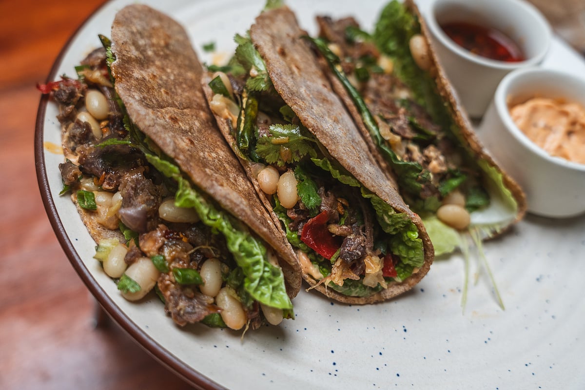Multigrain tacos made of equal portions of buckwheat, rice and corn flour stuffed with yak meat, white rajma, local seasonal greens, and mayo. This is a spin on the classic bes/cheptang (buckwheat roti) of the Monpas