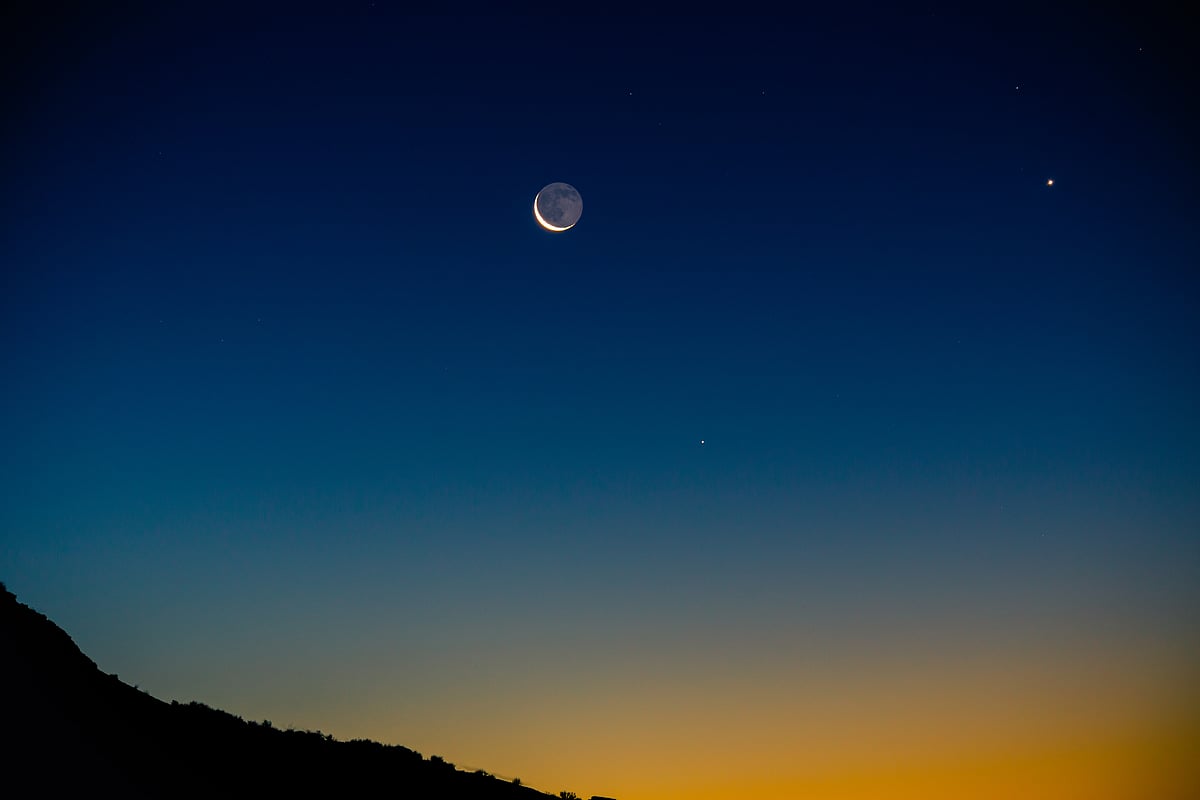 Crescent moon with earthshine next to Venus (right)