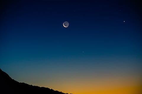 Crescent moon with earthshine next to Venus (right)