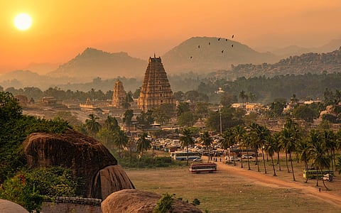 The stunning Virupaksha temple with scenic Hampi landscape in the backdrop