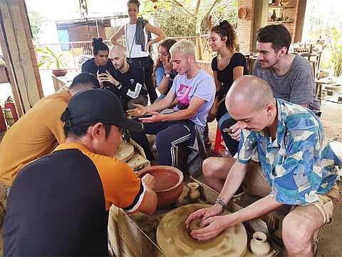 Sitting at the pottery wheel in Thanh Hà Terracotta Park