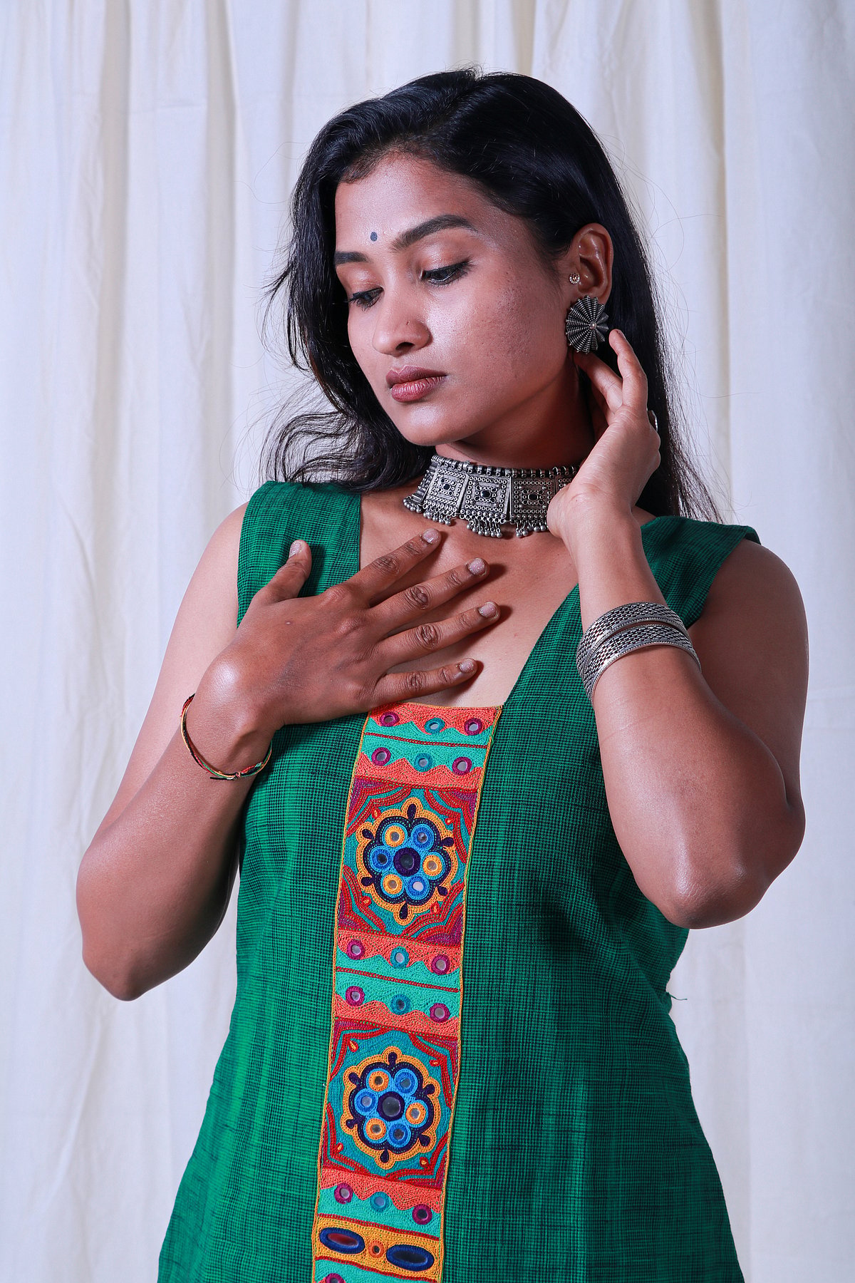 The green fabric is handloom cotton with Lambani mirror and thread panel