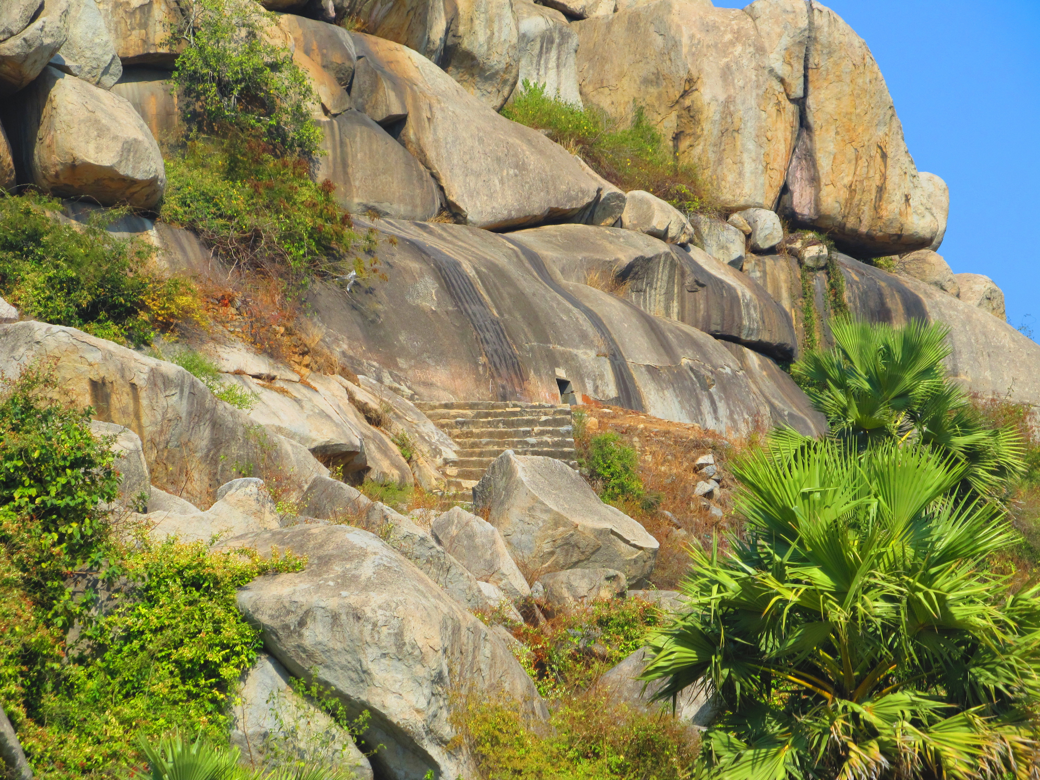 The setting of the Nagarjuni Caves with a tiny entrance