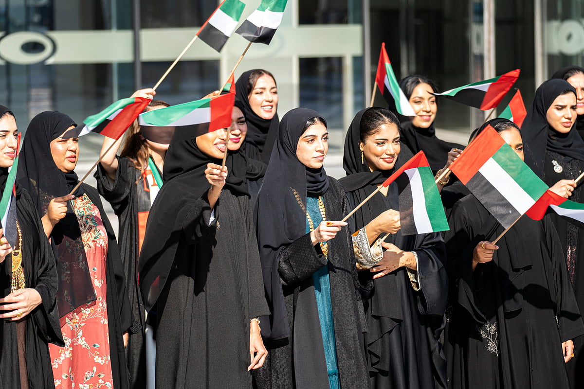 Women and girls wave UAE flags during National Day celebrations