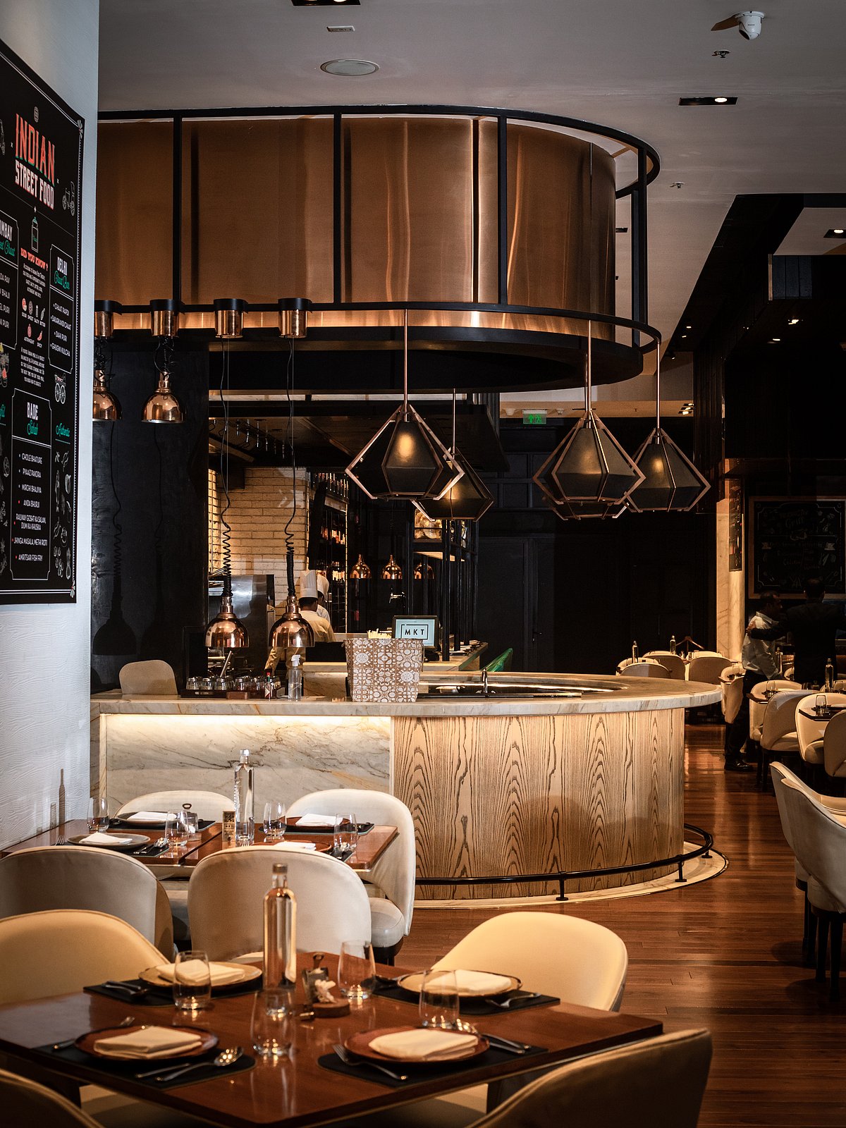 While MKT has been conceptualised as a food court, it never sticks out with its beautifully lit and sleek open kitchens, dim lighting, and gorgeous bar