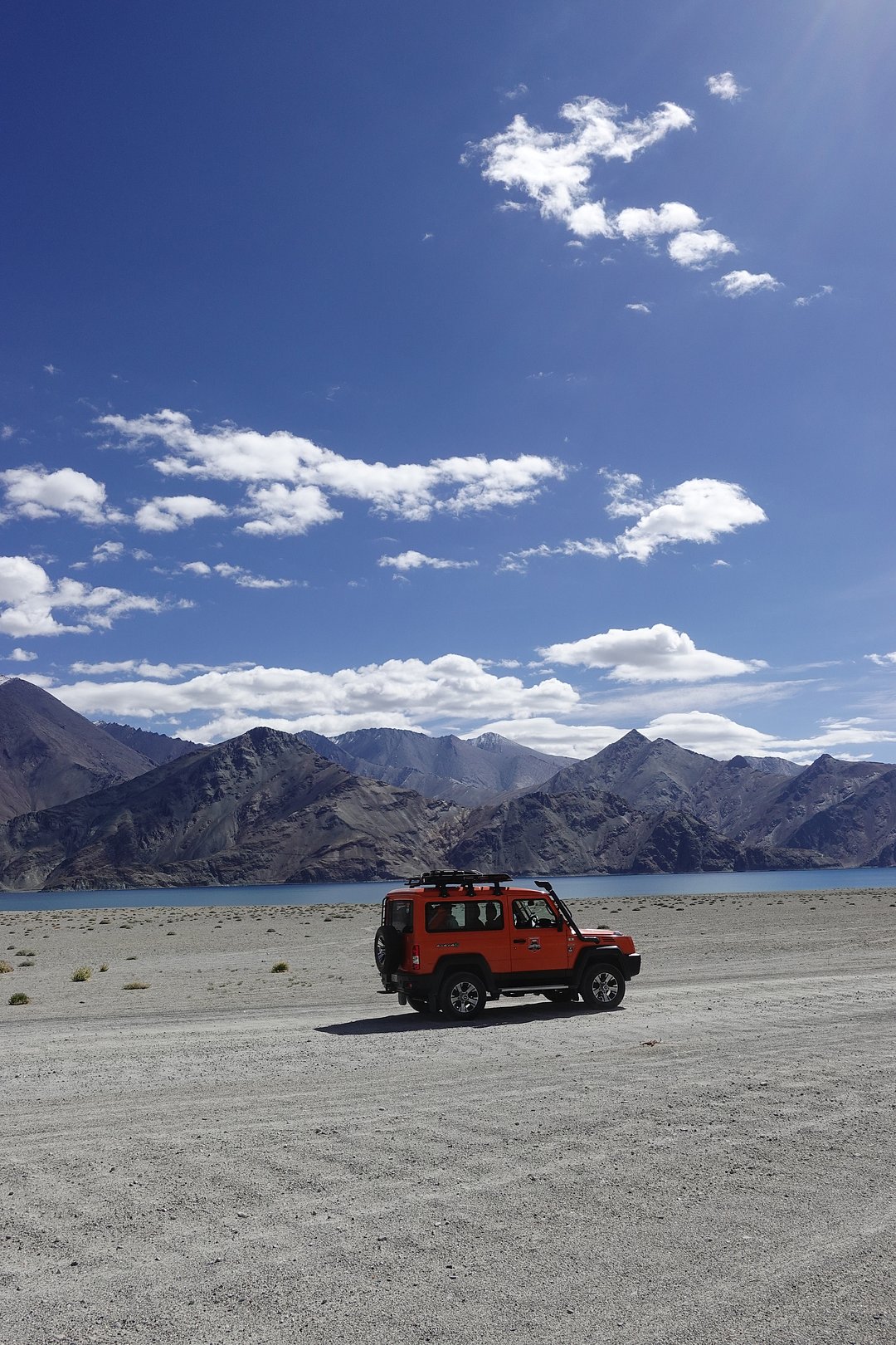 A jeep crosses through the terrain of Ladakh