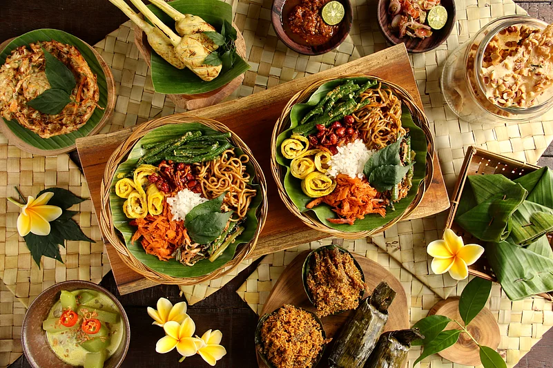 Popular Balinese meal of rice with variety side dishes, which are served together with the rice and more as optional extras