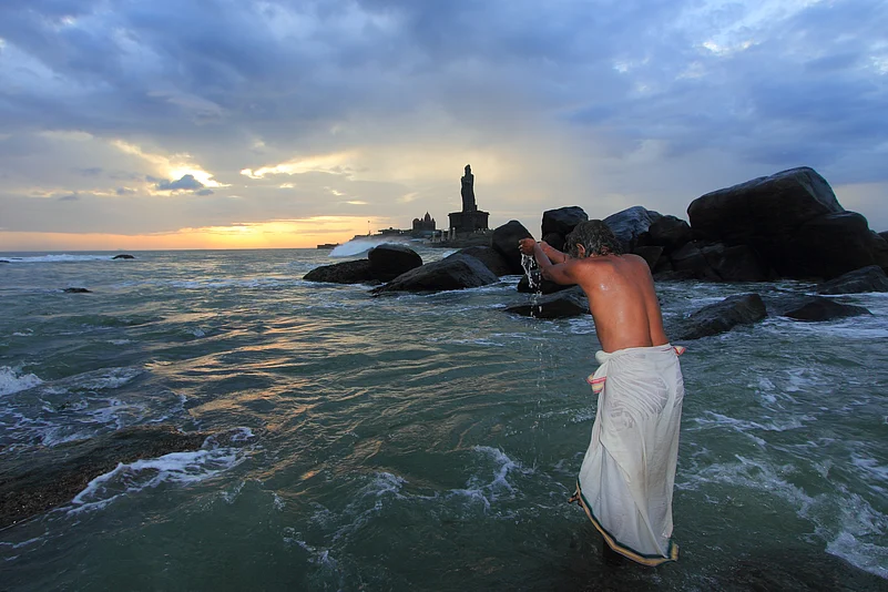 A devotee offering prayers near the Vivekananda Rock Memorial
