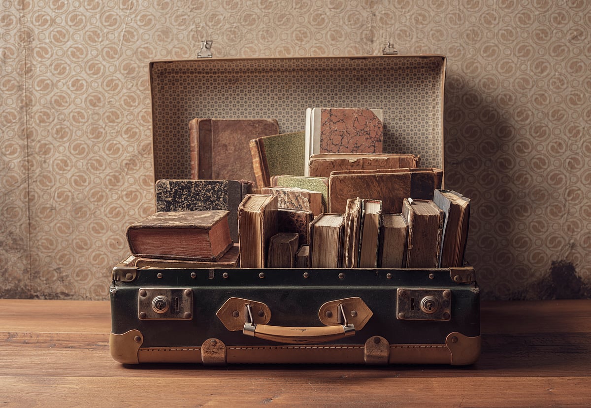 Heavy items like books and shoes should be placed near the wheels of the suitcase for stability