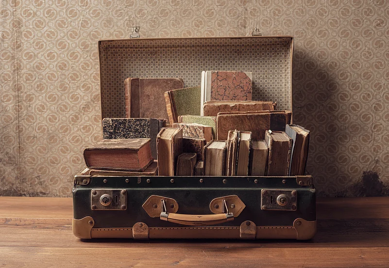 Heavy items like books and shoes should be placed near the wheels of the suitcase for stability