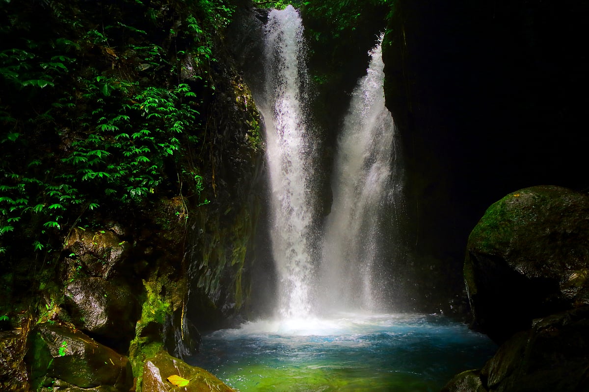 The Gitgit Twin Waterfall divides off into two tiers to crash down on the rocks below