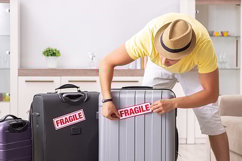 Let your airline know that you are carrying fragile items in your baggage and affix a sticker which says so