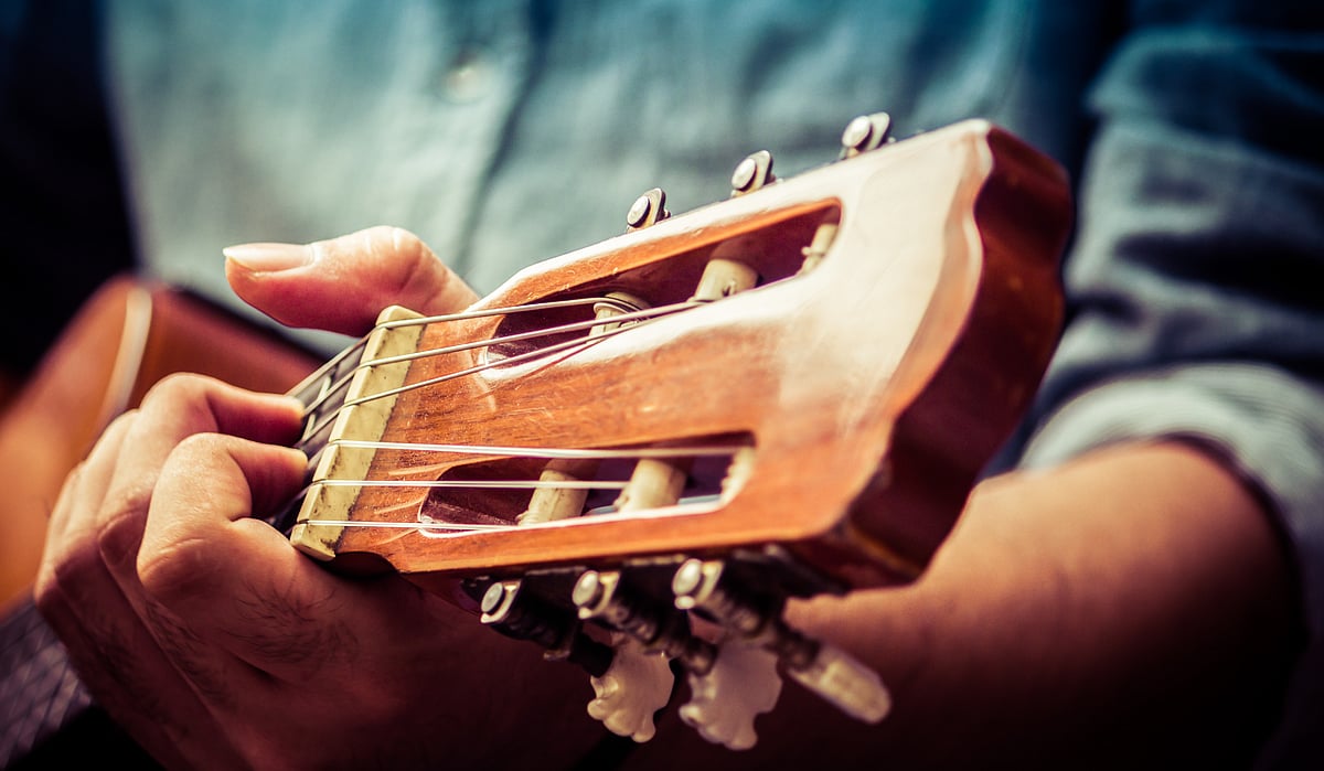 A man plays a guitar at an event