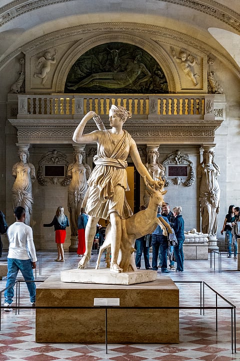 The ancient Roman sculpture of Diana the Huntress in the Hall of the Caryatids in the Louvre Museum.