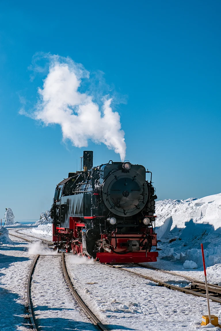 Steam train on the way to Brocken through the winter landscape in Harz National Park, Germany - Shutterstock