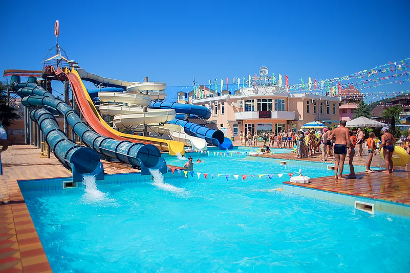 People enjoying in a pool park on a hot summer day