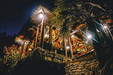 Glass
conservatory lit up
on a starry night