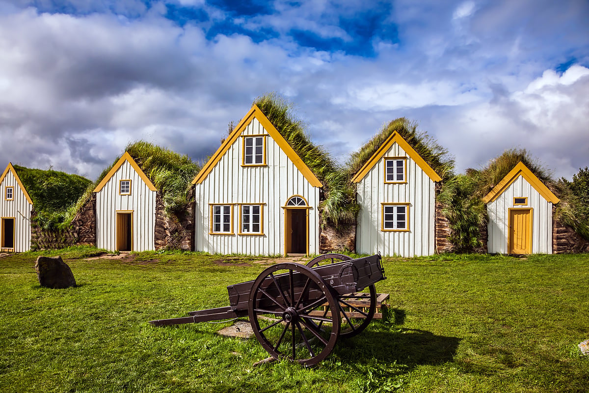 Facade of the farmhouse and ancient rural wheelbarrow in Iceland