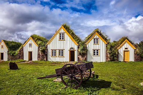 Facade of the farmhouse and ancient rural wheelbarrow in Iceland