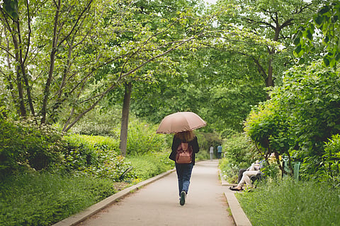 A woman walks in the Coulée verte René-Dumont, an elevated linear park in the 12th arrondissement of Paris