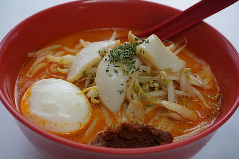 Laksa features thick rice vermicelli, known as bee hoon, immersed in a spicy broth