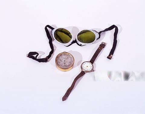 Mallory's essentials: goggles, altimeter, and wristwatch adorned with a leather strap