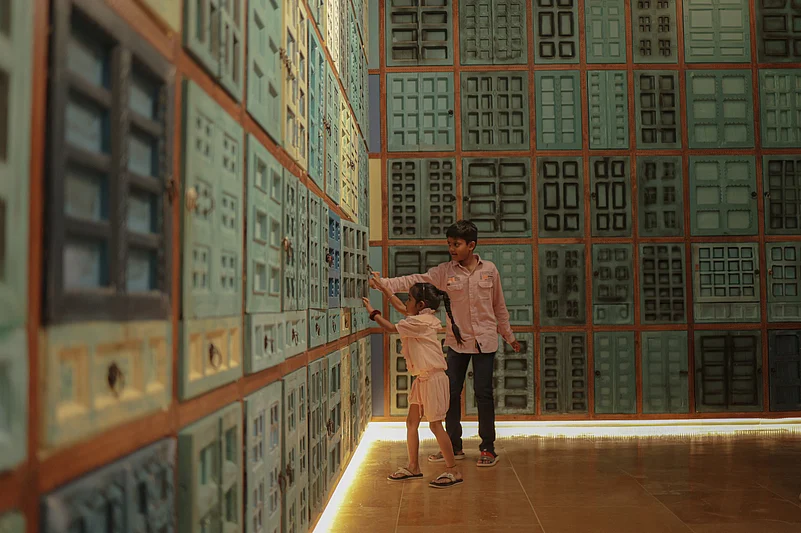 This exhibit with multiple doors and windows showcases a few of the stories from the recent history of Gujarat