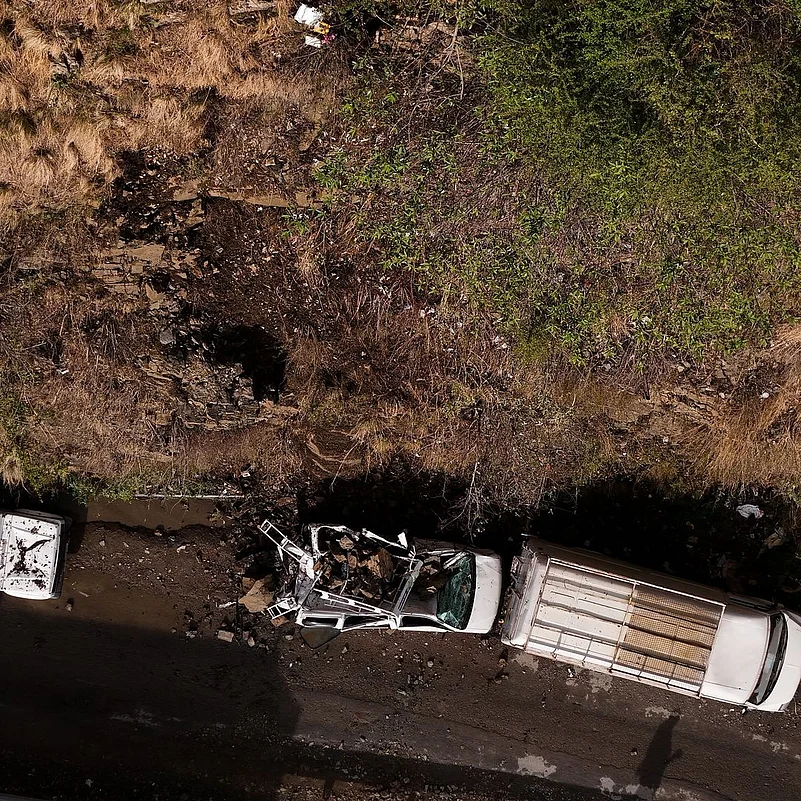 A damaged vehicle on Churath Nala Road in Shimla