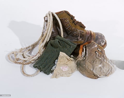 George Mallory's belongings: hobnail boot, fragments of a second boot and climbing rope, single fingerless glove, and cloth fragment with labels