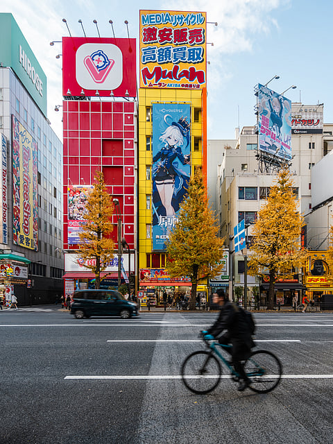 A person cycles through Akihabara, Tokyo