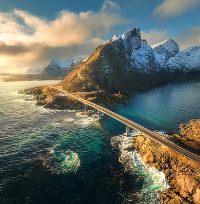 Shutterstock : Aerial view of bridge, sea with waves and mountains at sunset in Lofoten Islands, Norway