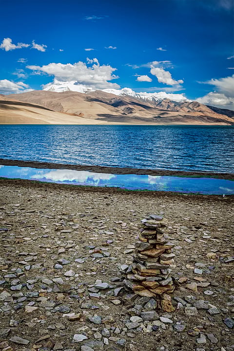 Stone cairn at Himalayan lake Tso Moriri, Korzok
