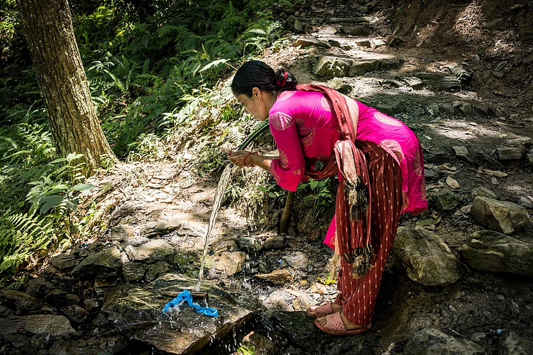 A woman using spring-fed water for her daily chores - Copyright: Jitendra Raj Bajracharya/ICIMOD