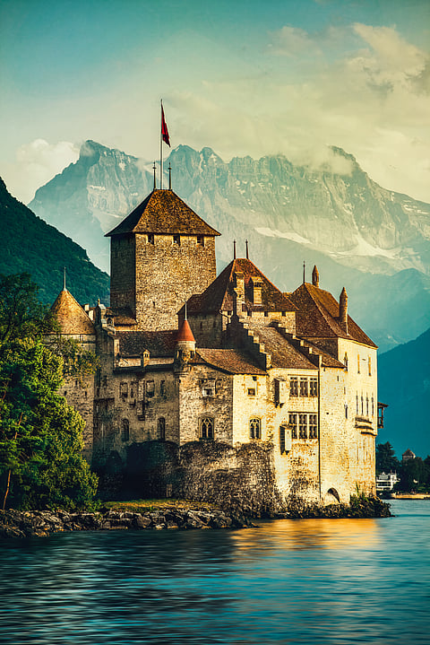 Beautiful sunset of Chillon Castle with Mont Blanc at Geneva lake, Switzerland