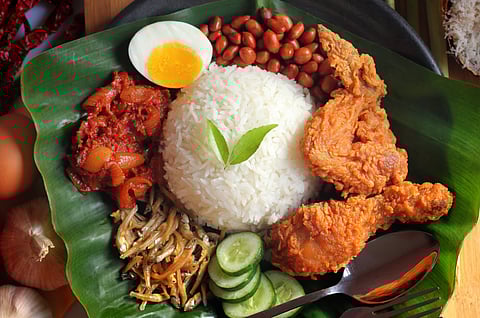 Nasi Lemak includes deep-fried chicken and turmeric-dusted fried kuning fish