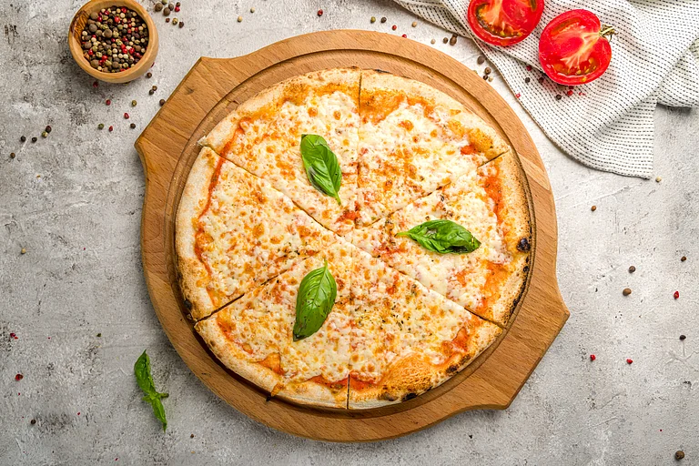 Italian pizza Margherita with cheese, tomato sauce and basil - Shutterstock