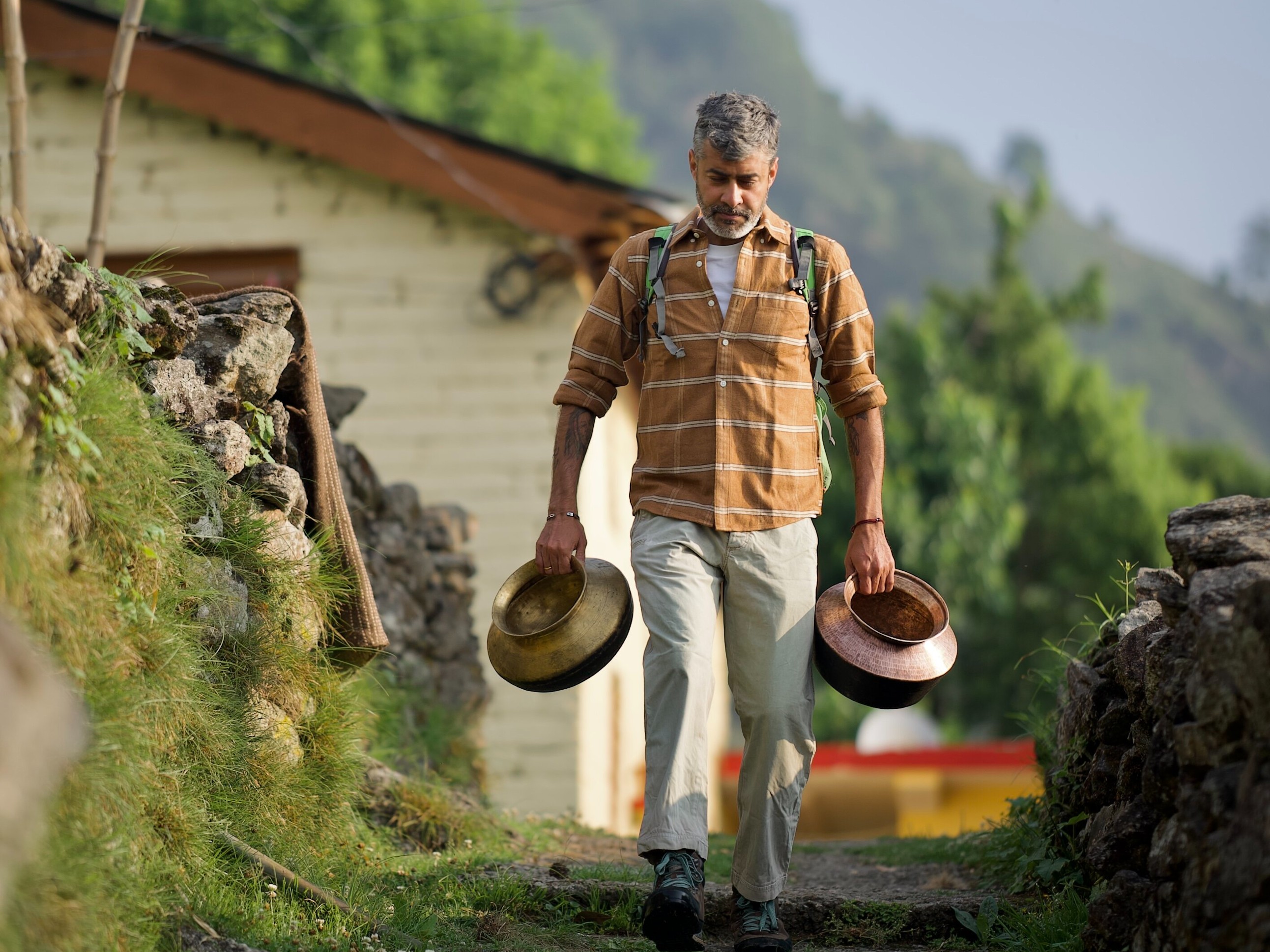 Organiser Ashish Verma carrying traditional vessels as part of the preparations for the food festival