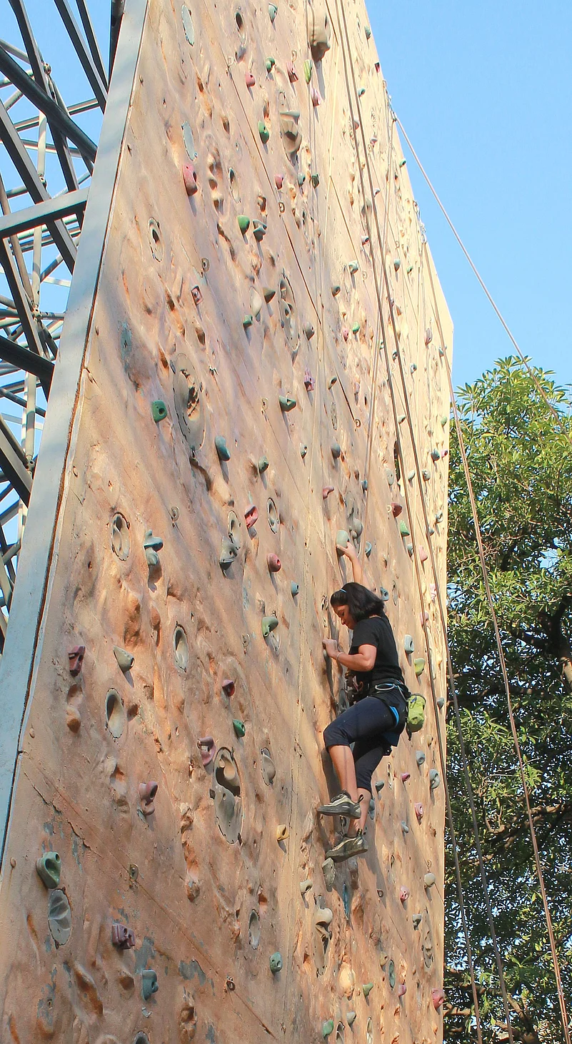 A climber trying their hands at the rock wall